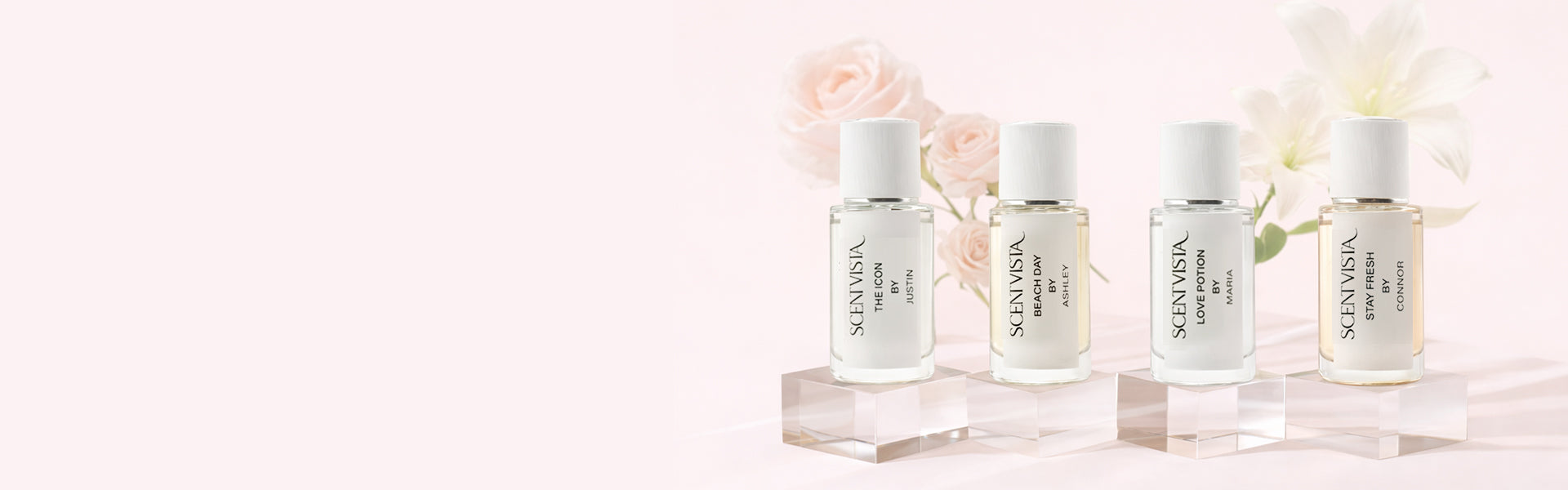 Fragrance bottles with a light pink background.