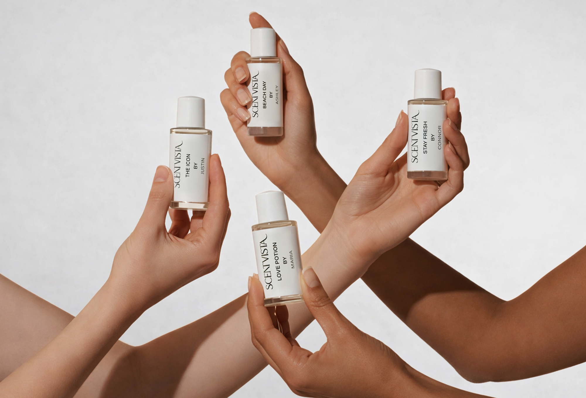 Multiple hands holding custom fragrance bottles with a neutral background