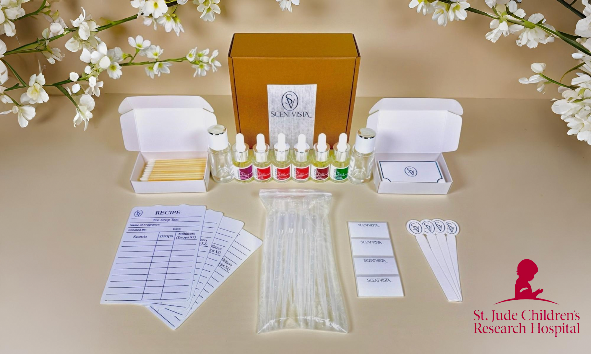 A Scentvista fragrance kit on a beige background with white flowers and the logo of St. Jude Children's Research Hospital in the lower right hand corner.